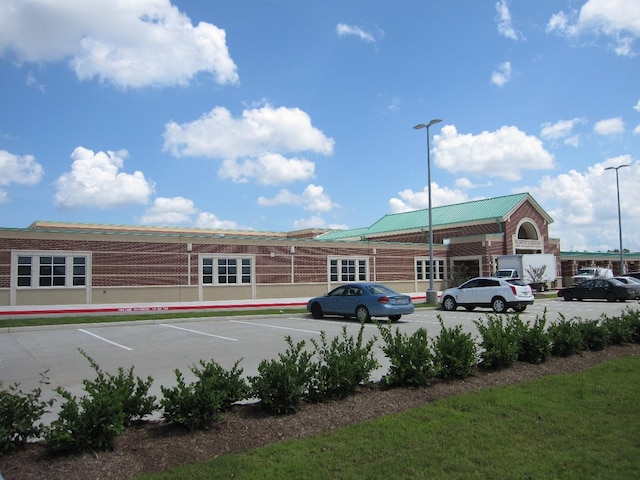 view of building exterior featuring uncovered parking
