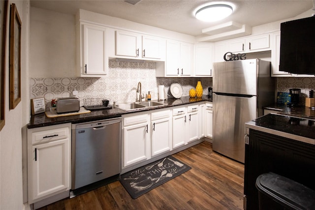 2817 Southmore Blvd, Houston, TX 77004 - kitchen featuring white cabinetry, stainless steel appliances, dark wood-style floors, and a sink