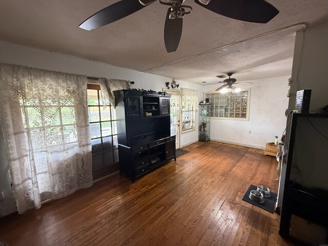 9341 Rosstown Way, Houston, TX 77080 - living room with ceiling fan, hardwood / wood-style flooring, a textured ceiling, and baseboards