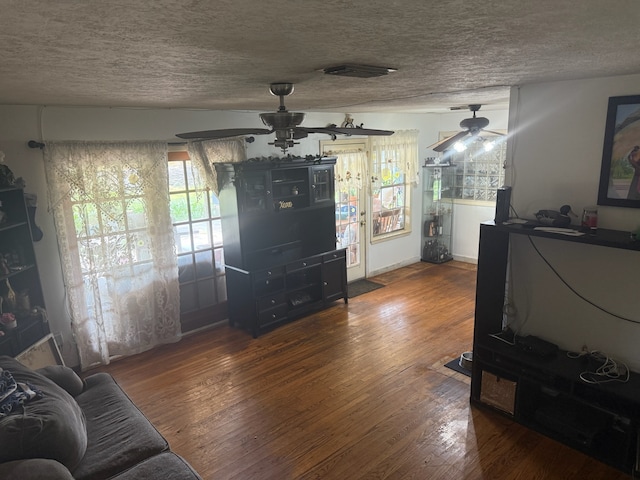 9341 Rosstown Way, Houston, TX 77080 - living area with ceiling fan, a textured ceiling, and wood finished floors