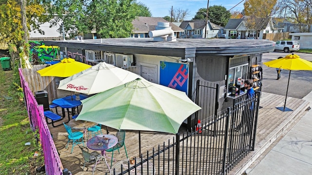 exterior space with a residential view, fence, and a deck