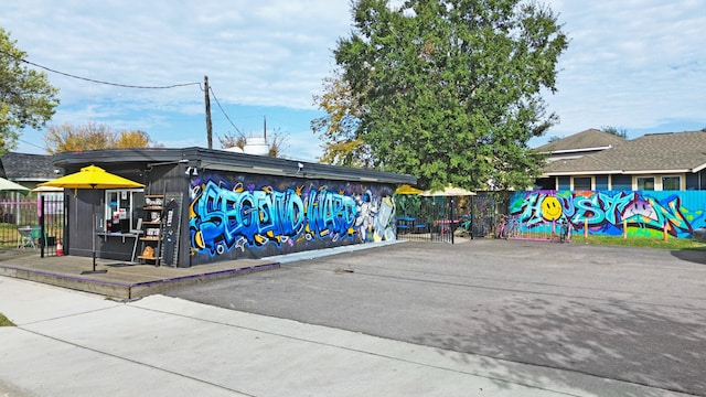view of home's community featuring fence