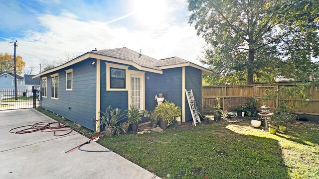 view of home's exterior featuring a yard, a patio, and a fenced backyard