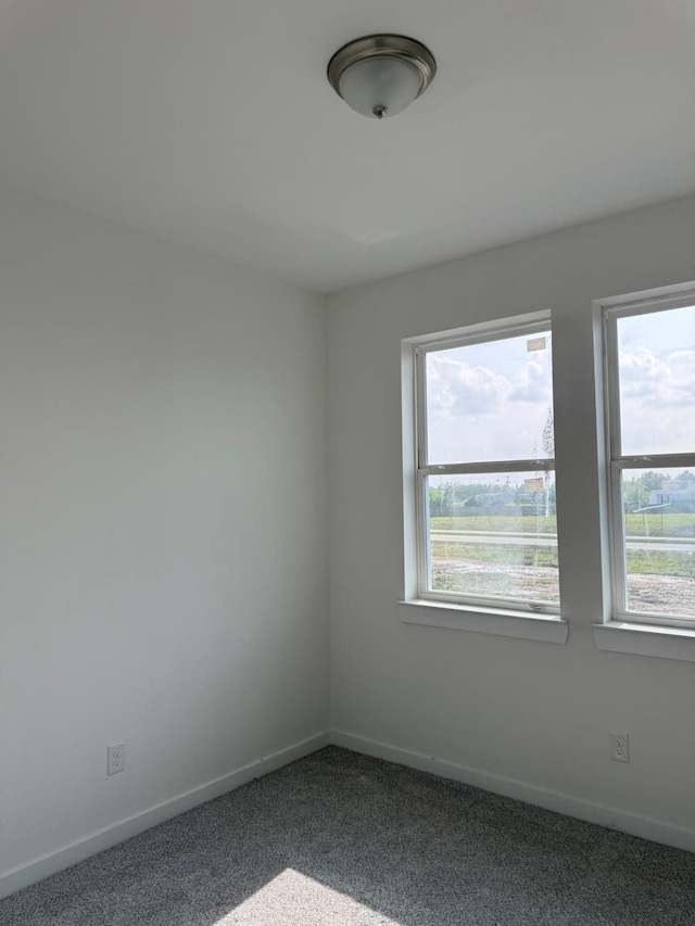 6149 Rd 5503, Cleveland, TX 77327 - spare room with baseboards and dark colored carpet