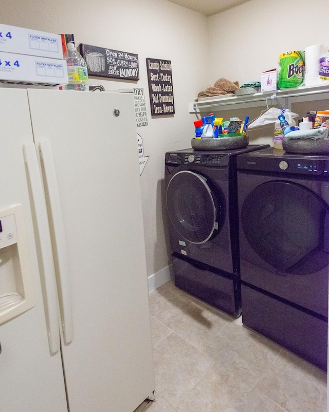 11903 Muir Groves Trl, Humble, TX 77346 - clothes washing area featuring washing machine and clothes dryer, laundry area, and light tile patterned floors