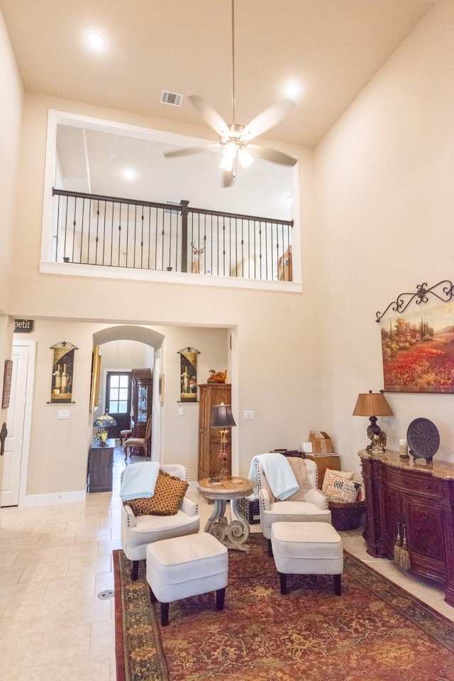 11903 Muir Groves Trl, Humble, TX 77346 - living area featuring a towering ceiling, a ceiling fan, and arched walkways