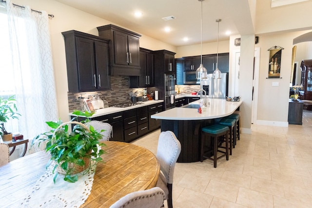11903 Muir Groves Trl, Humble, TX 77346 - kitchen with a breakfast bar area, stainless steel appliances, a sink, backsplash, and light countertops