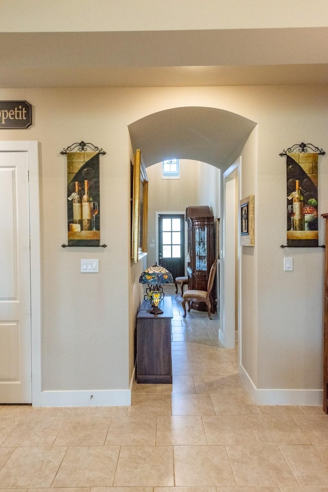 11903 Muir Groves Trl, Humble, TX 77346 - hall with light tile patterned floors, baseboards, and arched walkways