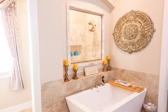 11903 Muir Groves Trl, Humble, TX 77346 - bathroom with a sink, a soaking tub, and tile walls
