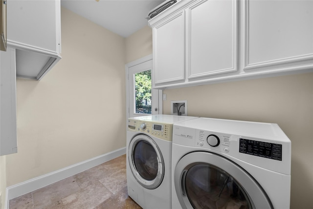 20105 Hilltop Ranch Dr, Montgomery, TX 77316 - clothes washing area featuring separate washer and dryer, baseboards, stone finish floor, and cabinet space