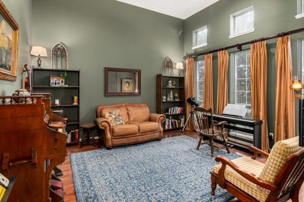 sitting room with wood finished floors and a high ceiling