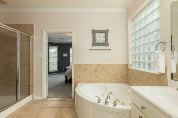 bathroom featuring a shower stall, tile patterned flooring, a tub with jets, and ornamental molding
