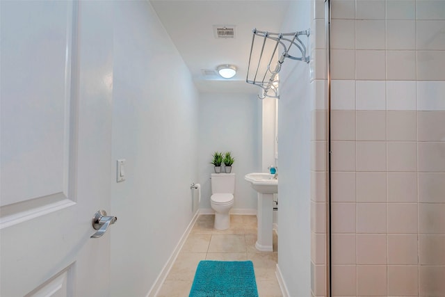 801 E Beach Dr Unit Tw1012, Galveston, TX 77550 - full bathroom featuring toilet, tiled shower, and tile patterned flooring