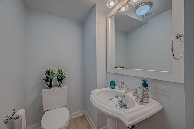 801 E Beach Dr Unit Tw1012, Galveston, TX 77550 - half bath featuring a sink, toilet, and baseboards
