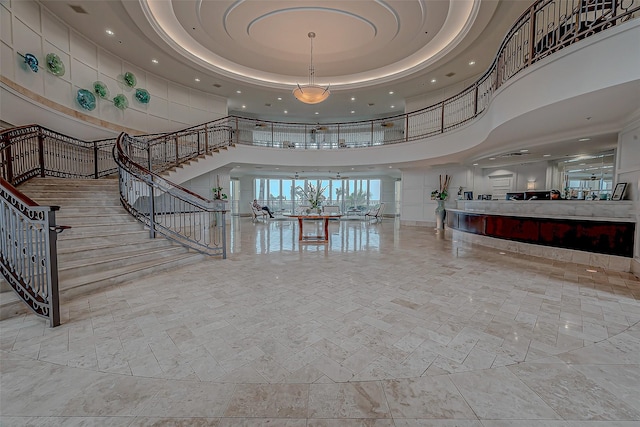 801 E Beach Dr Unit Tw1012, Galveston, TX 77550 - stairs featuring a towering ceiling, recessed lighting, and a raised ceiling