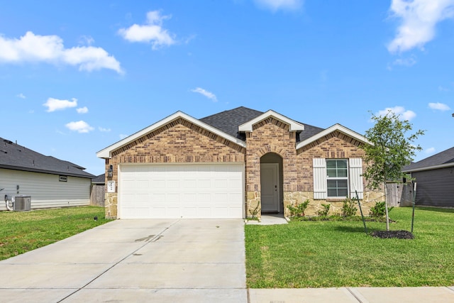 ranch-style home featuring central air condition unit, concrete driveway, a front lawn, an attached garage, and brick siding