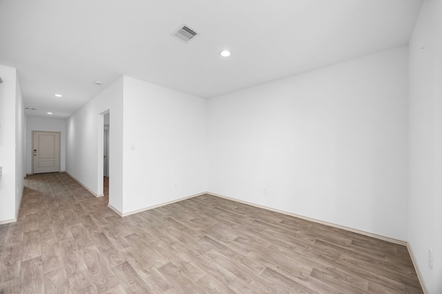 unfurnished room with baseboards, visible vents, recessed lighting, and light wood-style floors