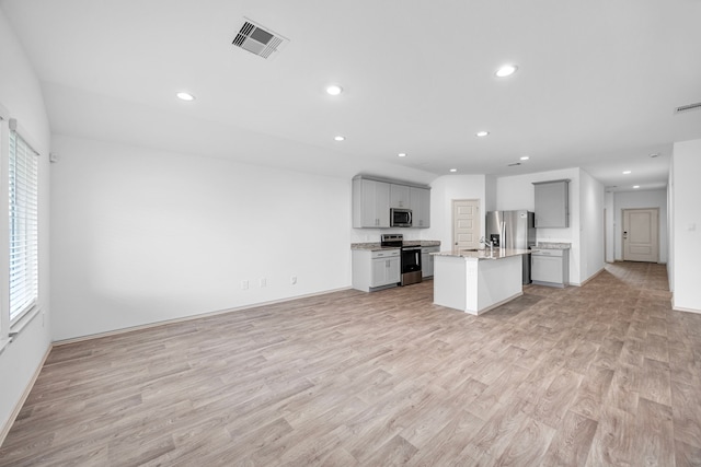 kitchen featuring recessed lighting, visible vents, open floor plan, and stainless steel appliances