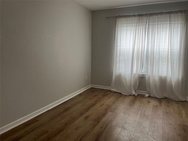 10555 Turtlewood Ct Unit 1008, Houston, TX 77072 - empty room with baseboards and dark wood-style flooring