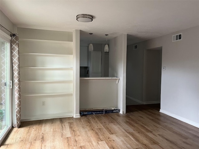 10555 Turtlewood Ct Unit 1008, Houston, TX 77072 - spare room featuring wood finished floors, visible vents, and baseboards