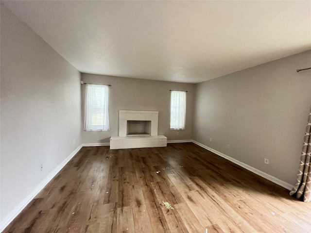 10555 Turtlewood Ct Unit 1008, Houston, TX 77072 - unfurnished living room with baseboards, wood finished floors, and a fireplace