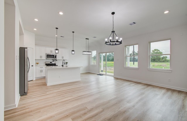 1920 1st St, Hempstead, TX 77445 - kitchen featuring light wood-style floors, visible vents, open floor plan, and stainless steel appliances