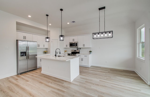 1920 1st St, Hempstead, TX 77445 - kitchen with light countertops, light wood-style flooring, stainless steel appliances, and a sink