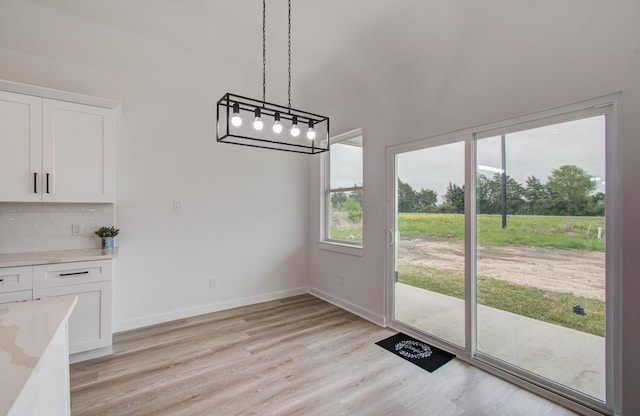 1920 1st St, Hempstead, TX 77445 - unfurnished dining area featuring baseboards and light wood-type flooring