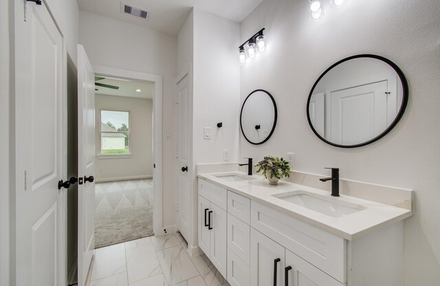 1920 1st St, Hempstead, TX 77445 - bathroom featuring visible vents, a sink, marble finish floor, and double vanity