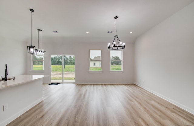 1920 1st St, Hempstead, TX 77445 - unfurnished dining area with an inviting chandelier, visible vents, light wood finished floors, and a wealth of natural light