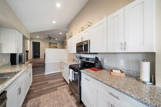 kitchen featuring recessed lighting, vaulted ceiling, dark wood-style flooring, appliances with stainless steel finishes, and white cabinetry