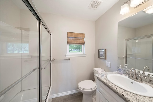 full bathroom featuring visible vents, toilet, baseboards, and a shower with door