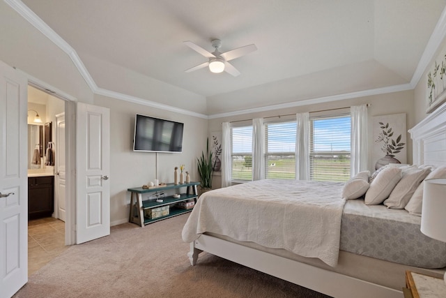 bedroom featuring light colored carpet, crown molding, connected bathroom, and a raised ceiling