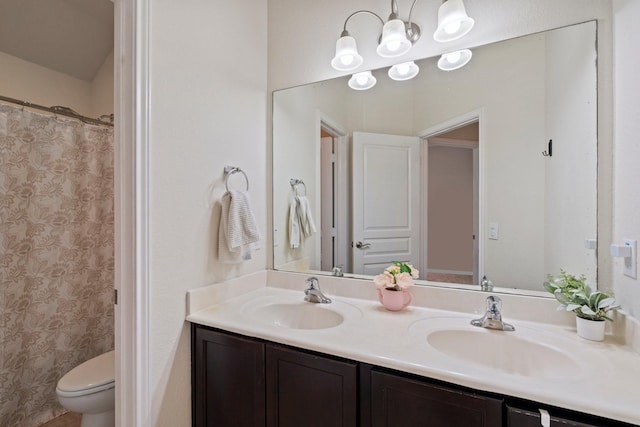 full bath featuring a sink, a shower with shower curtain, double vanity, and toilet