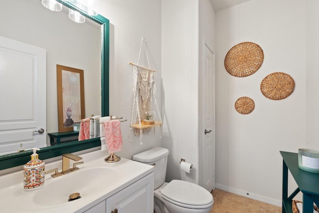 bathroom featuring tile patterned floors, baseboards, vanity, and toilet