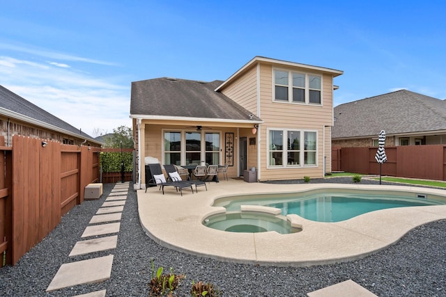 back of property with a patio area, a fenced backyard, a pool with connected hot tub, and ceiling fan