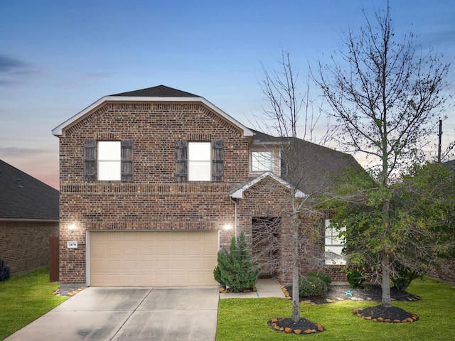 traditional home with an attached garage, brick siding, and concrete driveway