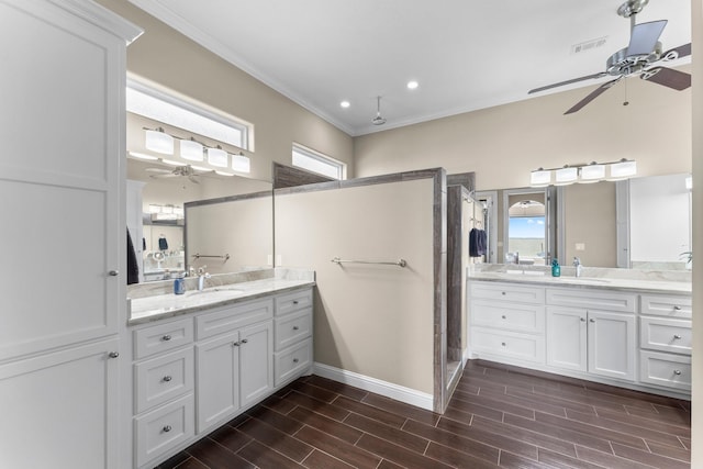 bathroom with visible vents, wood finish floors, ceiling fan, and tiled shower