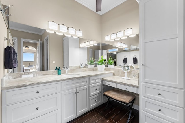 full bathroom with ceiling fan, wood finished floors, vanity, and ornamental molding