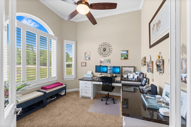 office featuring light colored carpet, a ceiling fan, crown molding, and plenty of natural light