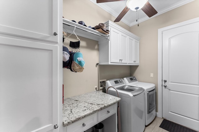 laundry room featuring crown molding, cabinet space, washer and clothes dryer, and ceiling fan