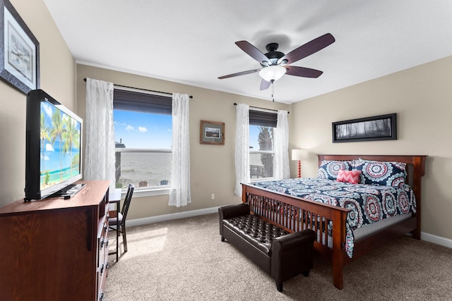 bedroom featuring baseboards, a ceiling fan, and carpet