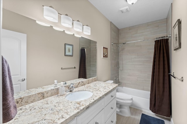 bathroom featuring shower / bath combo with shower curtain, visible vents, vanity, and toilet