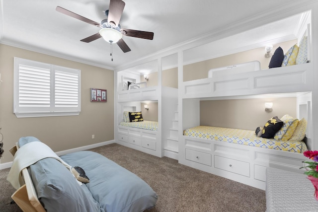 carpeted bedroom with ceiling fan, baseboards, and ornamental molding