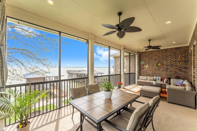 sunroom / solarium with a ceiling fan and an outdoor hangout area