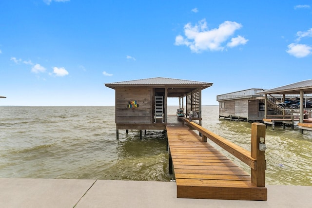 dock area with boat lift and a water view