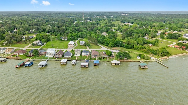drone / aerial view featuring a view of trees and a water view