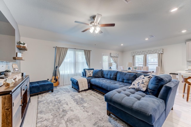 living area with a ceiling fan, light wood-style floors, and recessed lighting