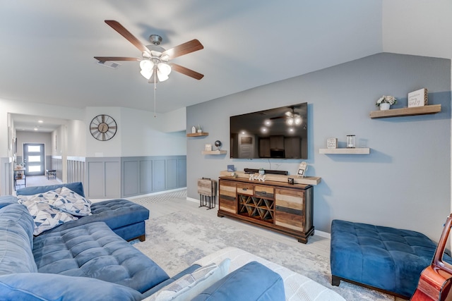 living room featuring vaulted ceiling, wood finished floors, visible vents, and ceiling fan