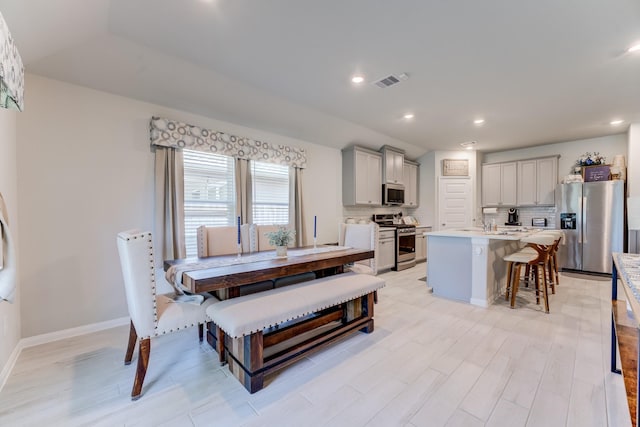 dining room featuring recessed lighting, light wood-style floors, and visible vents